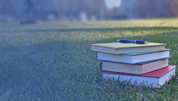 stack of books on grass