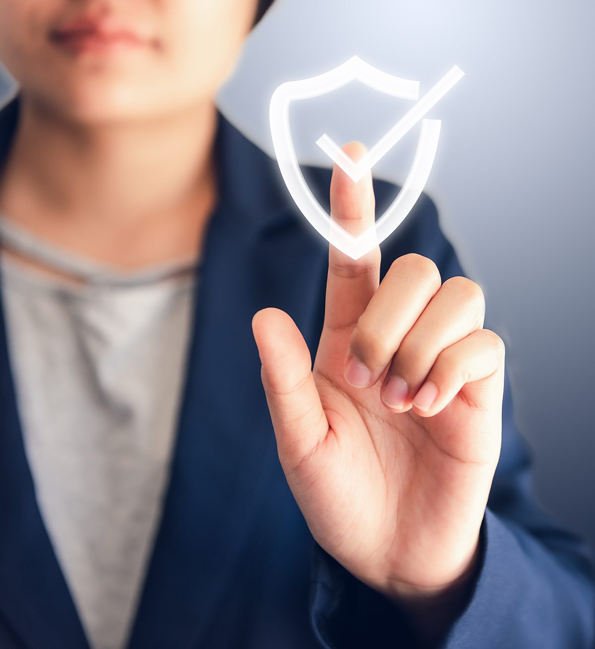 woman-pressing-screen-safety woman in suit pressing check mark on screen
