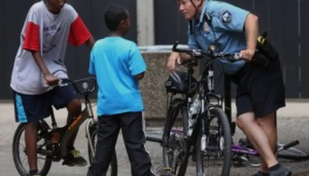 school officer on bicycle talking to kids