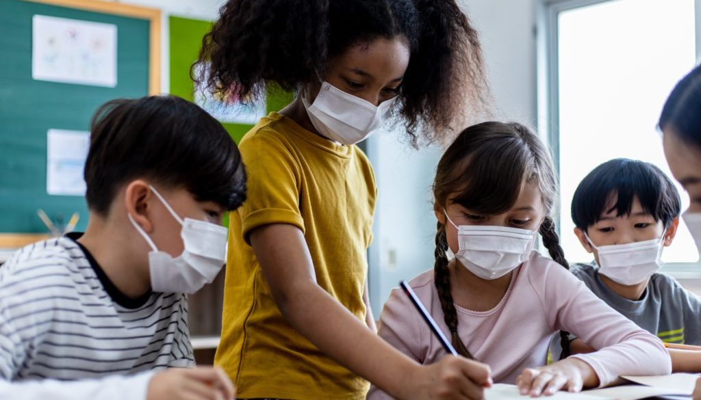 A Group Of Children Students Wearing Medical Masks In Classroom