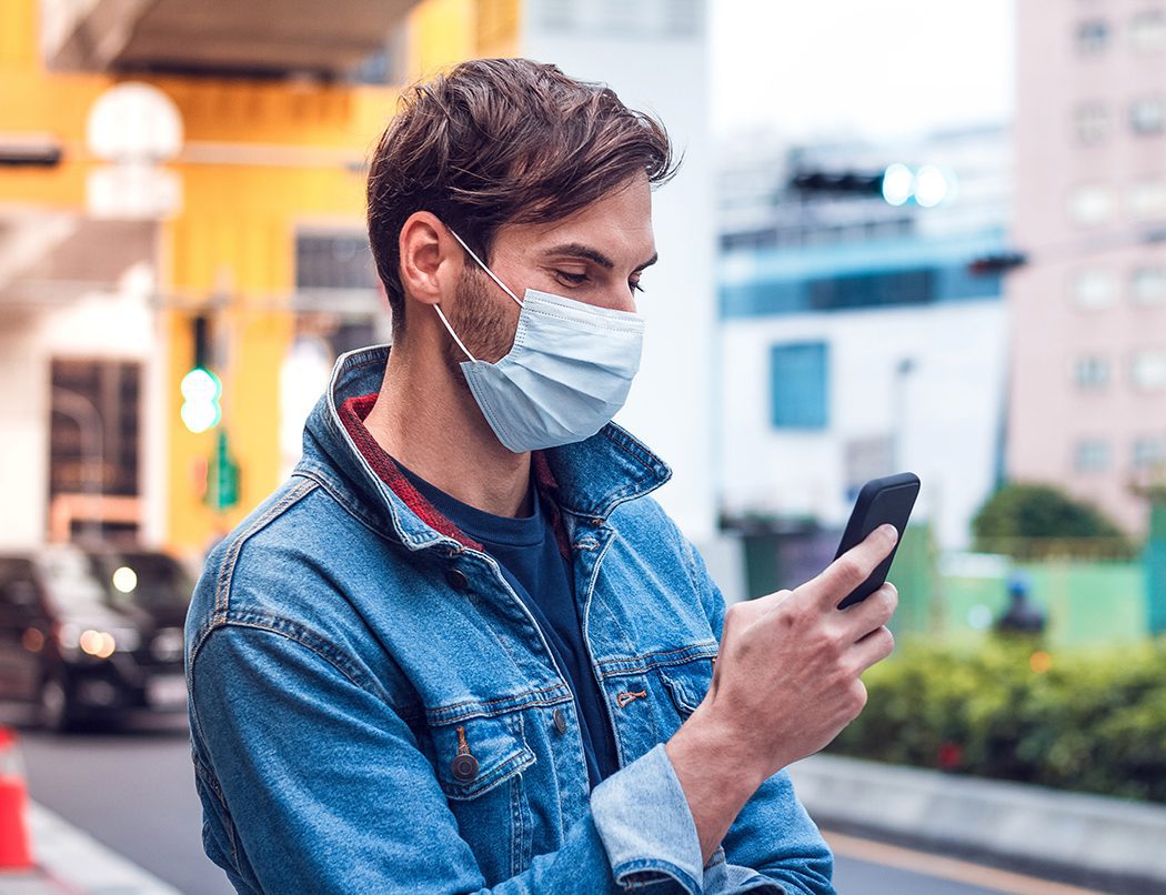 man-phone-mask man on phone outside wearing mask