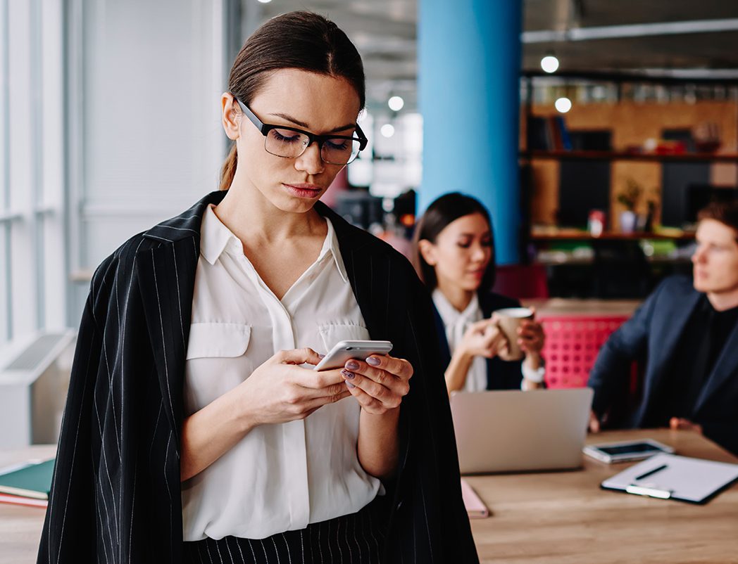 Serious Caucasian Businesswoman In Formal Wear Checking Notification On Mobile Serious Caucasian Businesswoman In Formal Wear Checking Notification On Mobile