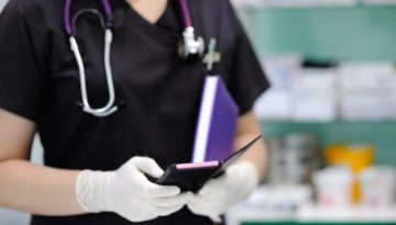 nurse using cell phone wearing scrubs