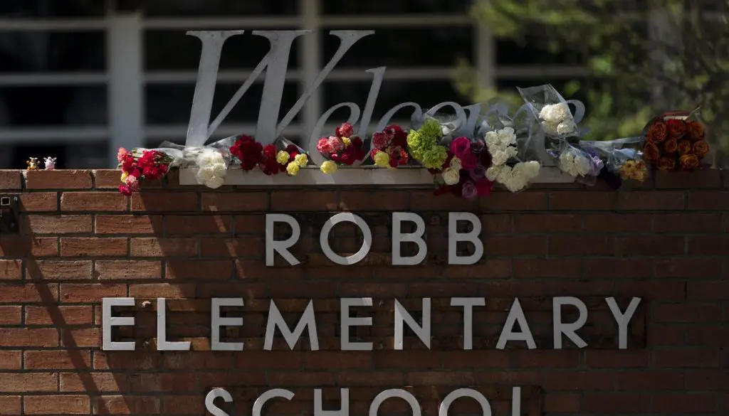 flowers on top of the Robb Elementary School sign