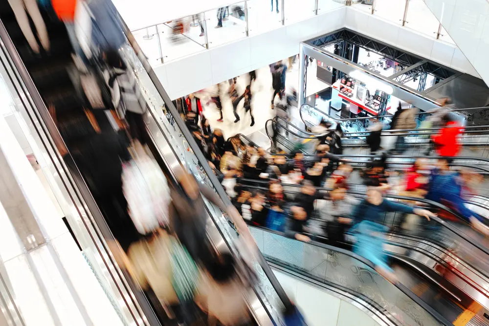mall shopping center people riding escalator