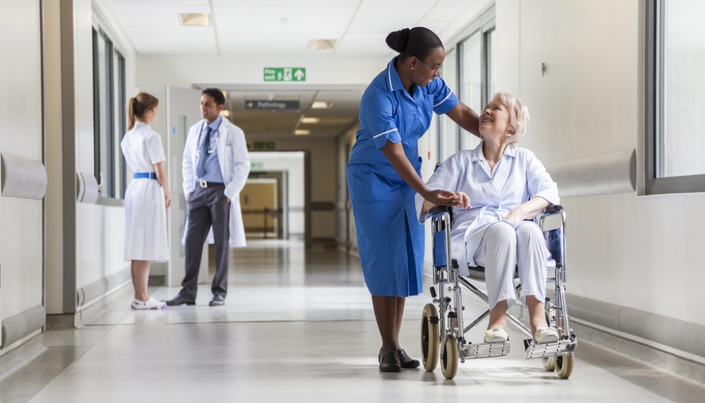 nurse pushing patient in a wheel chair