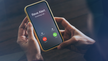 hands holding iPhone with rave alert calling on screen